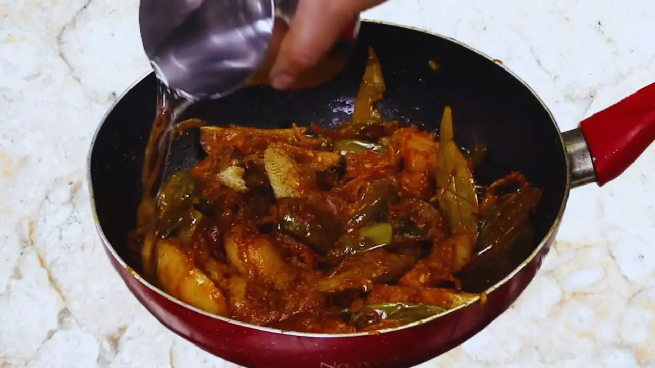 Aloo baingan curry recipe step 16 Adding water