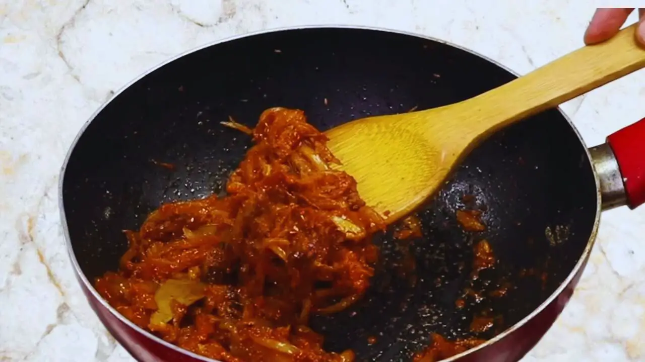Aloo baingan curry recipe step 13 Checking doneness of masala