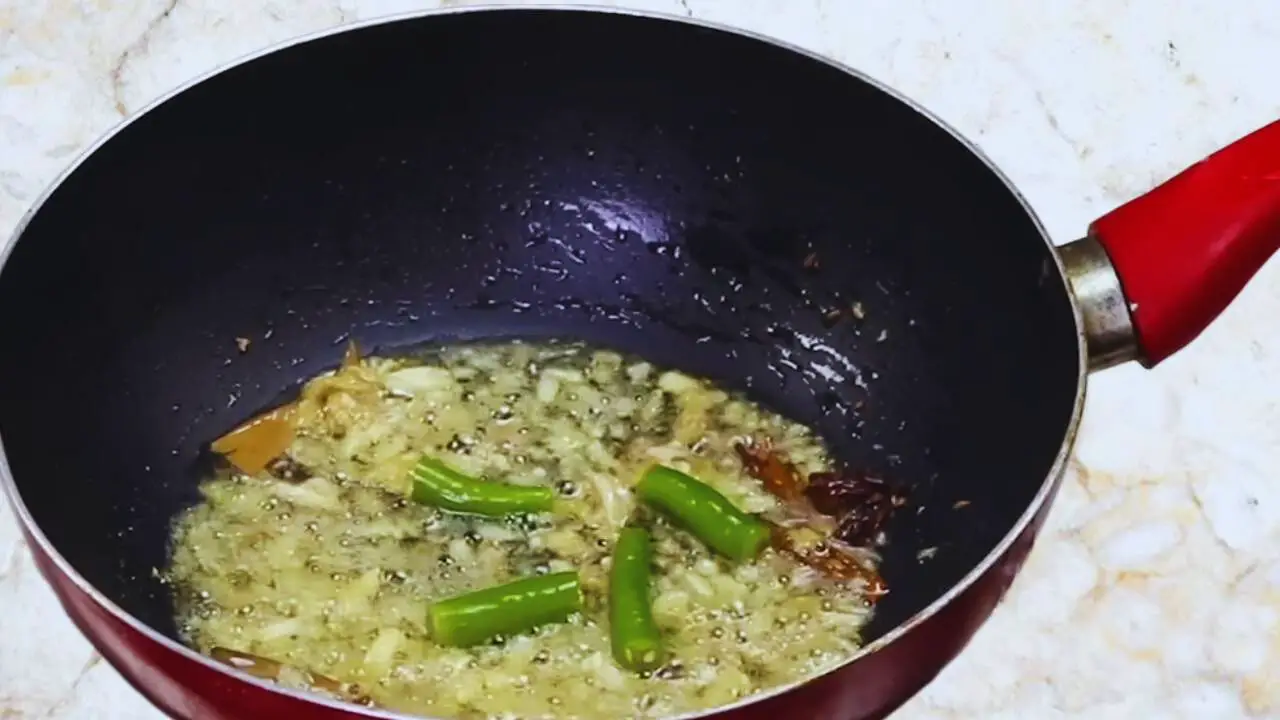 Aloo baingan curry recipe step 8 Frying green chilies