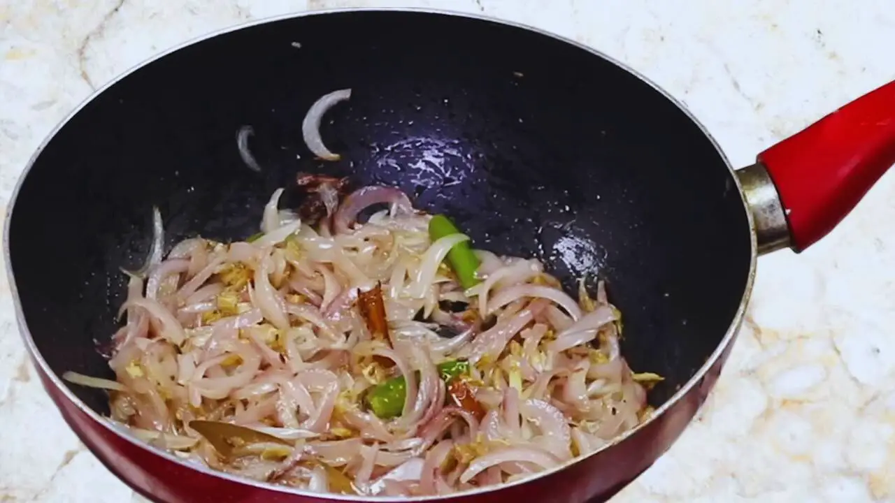 Aloo baingan curry recipe step 9 Frying onions