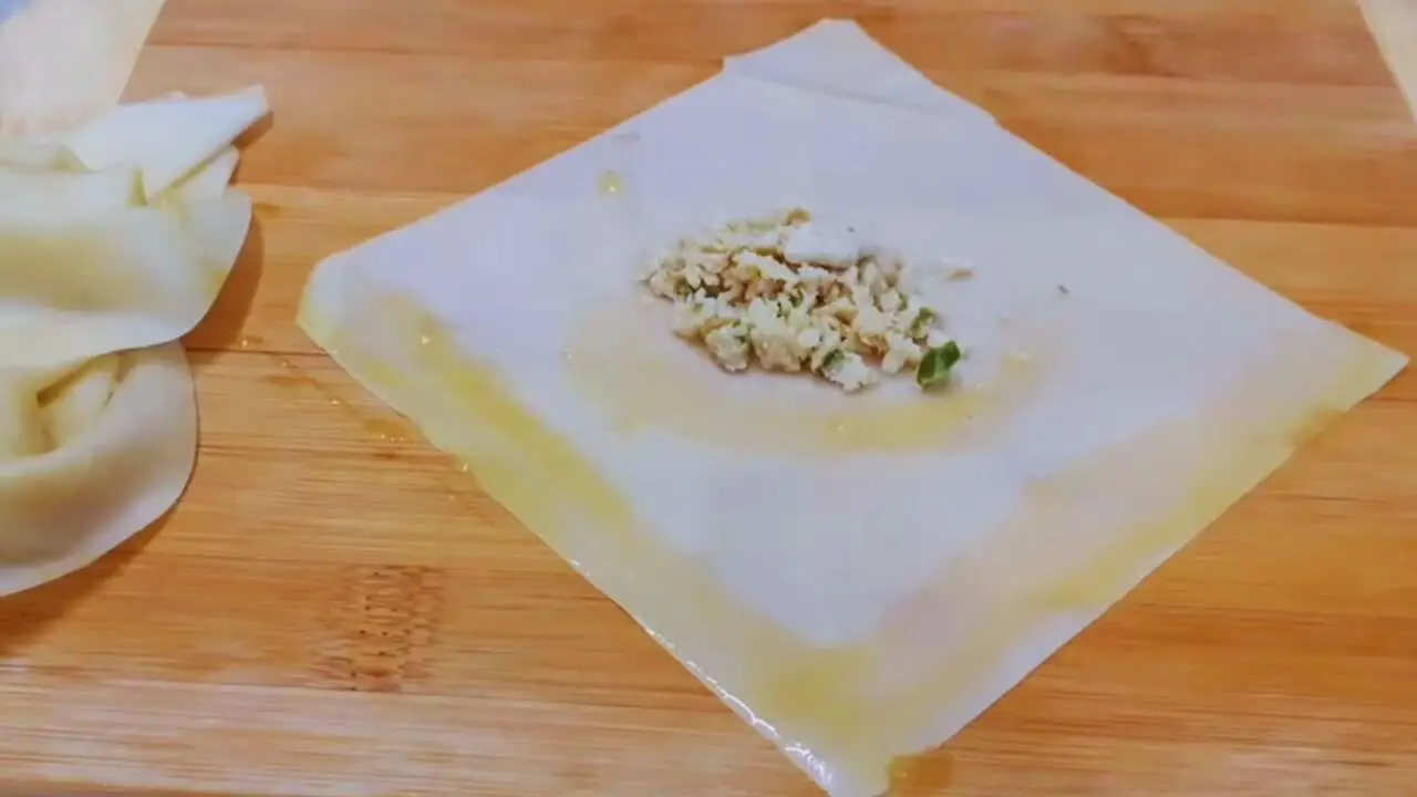 Placing chicken filling at the center 