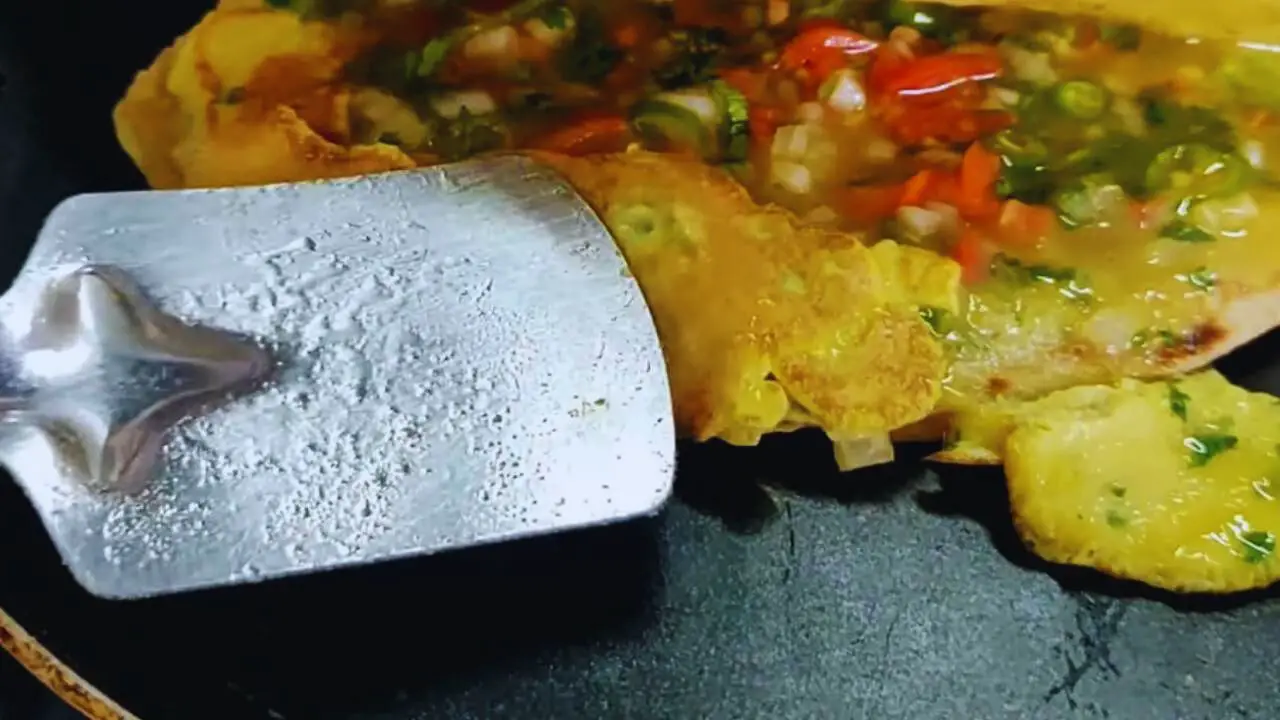 Putting overflown egg mixture inside 