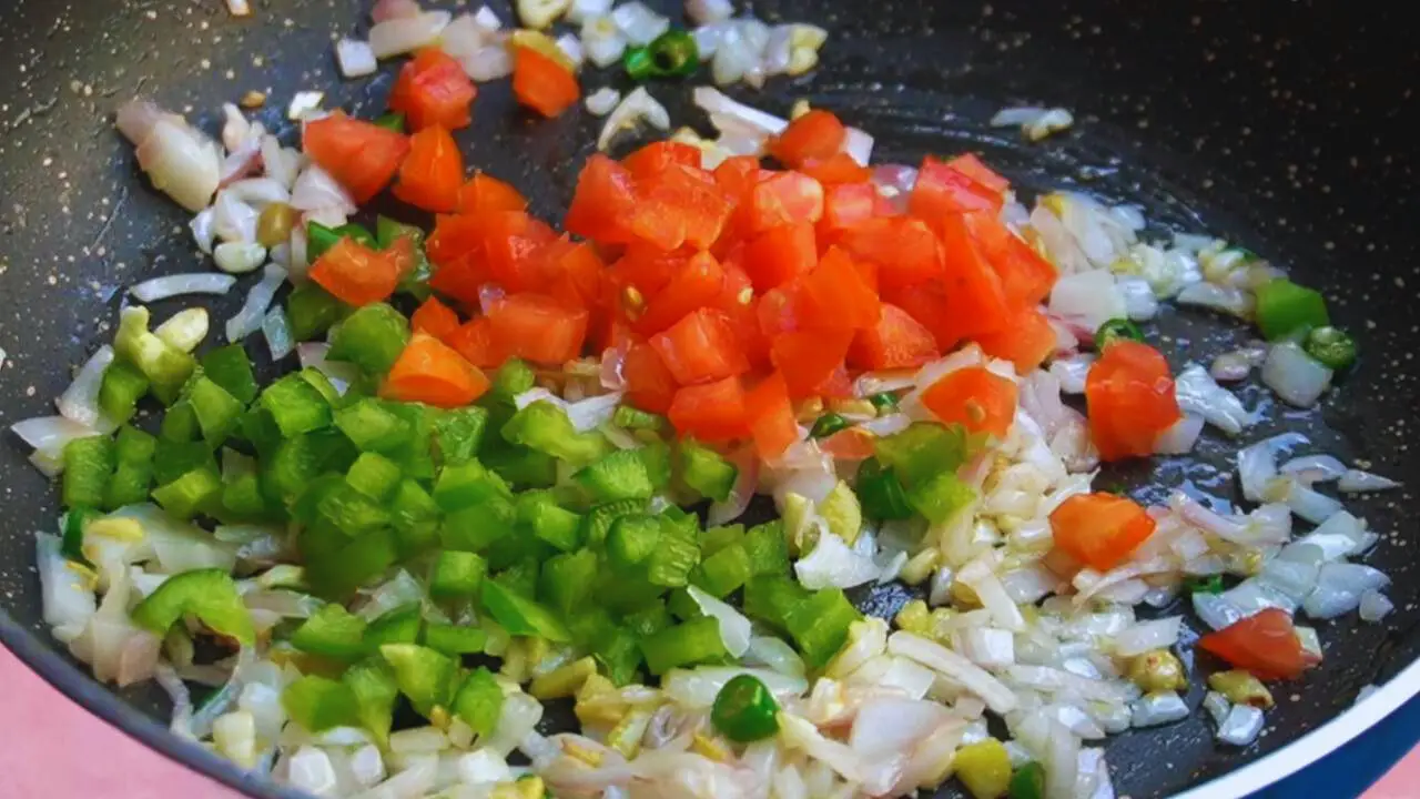 Adding tomatoes and capsicum