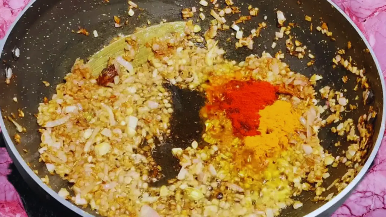 Adding turmeric and red chili powder