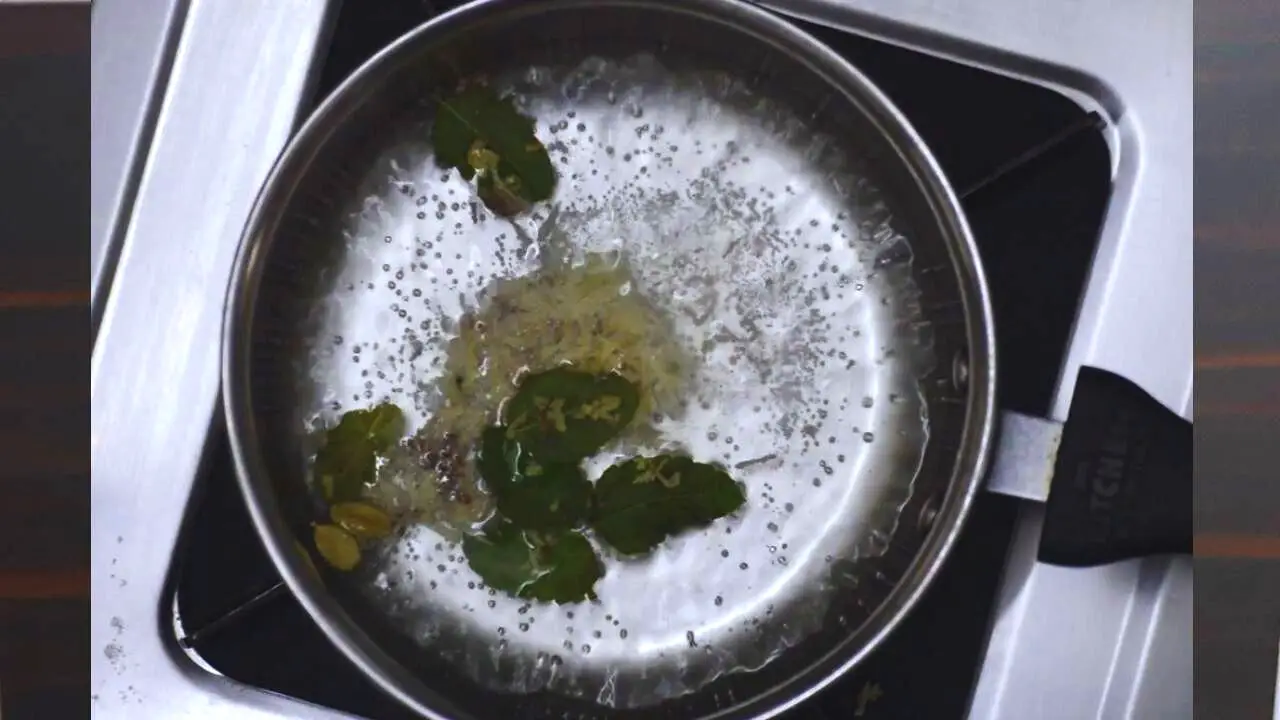 Tulsi tea recipe step 1 Boiling Tulsi and ginger in water