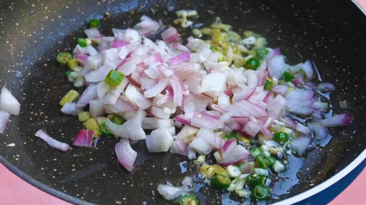 Frying onions and chilies 