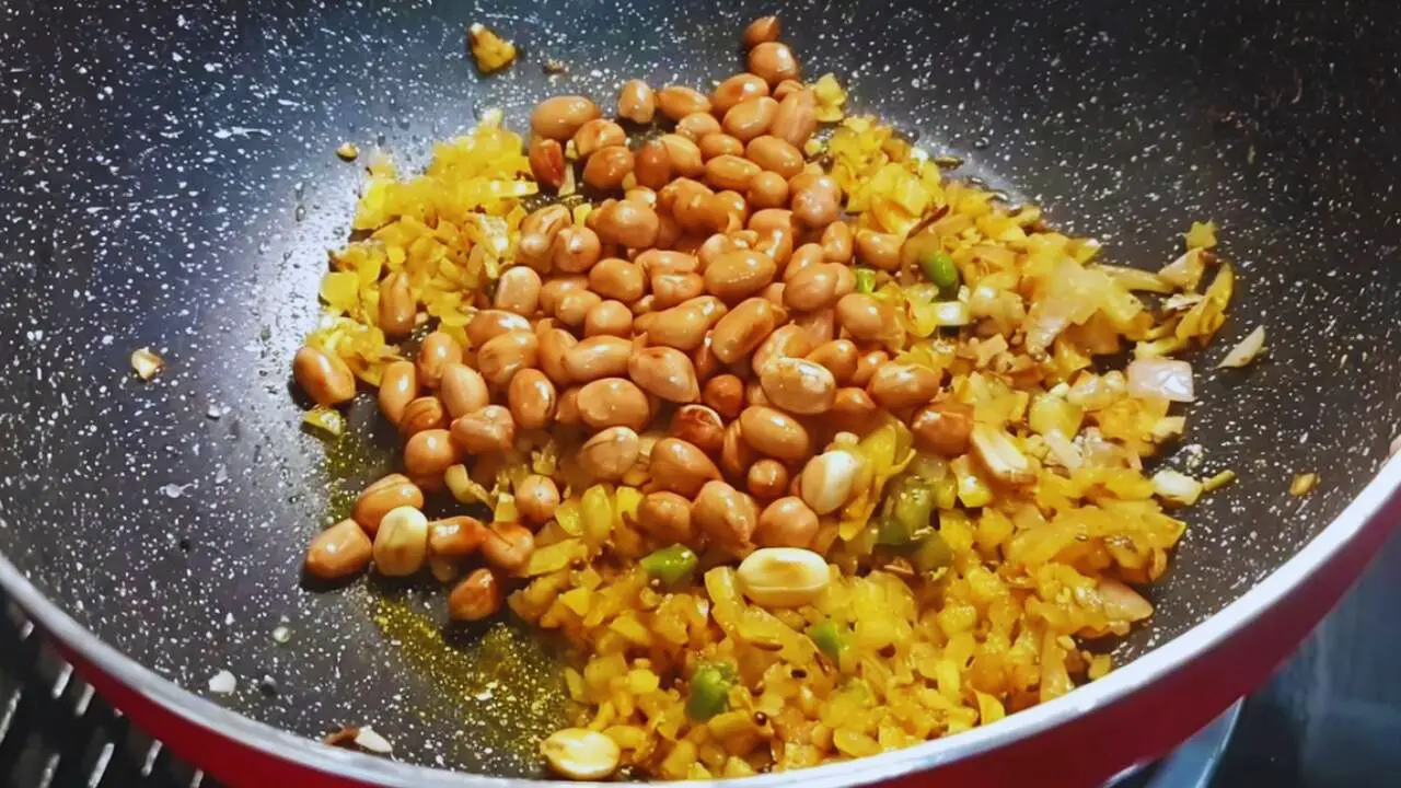 Poha recipe step 7 Adding fried peanuts