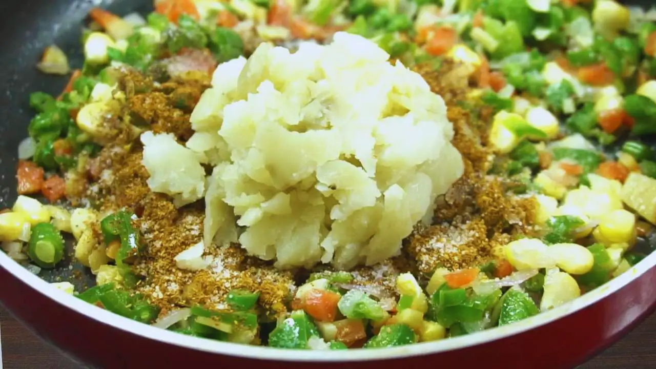 Adding powdered spices and boiled potato