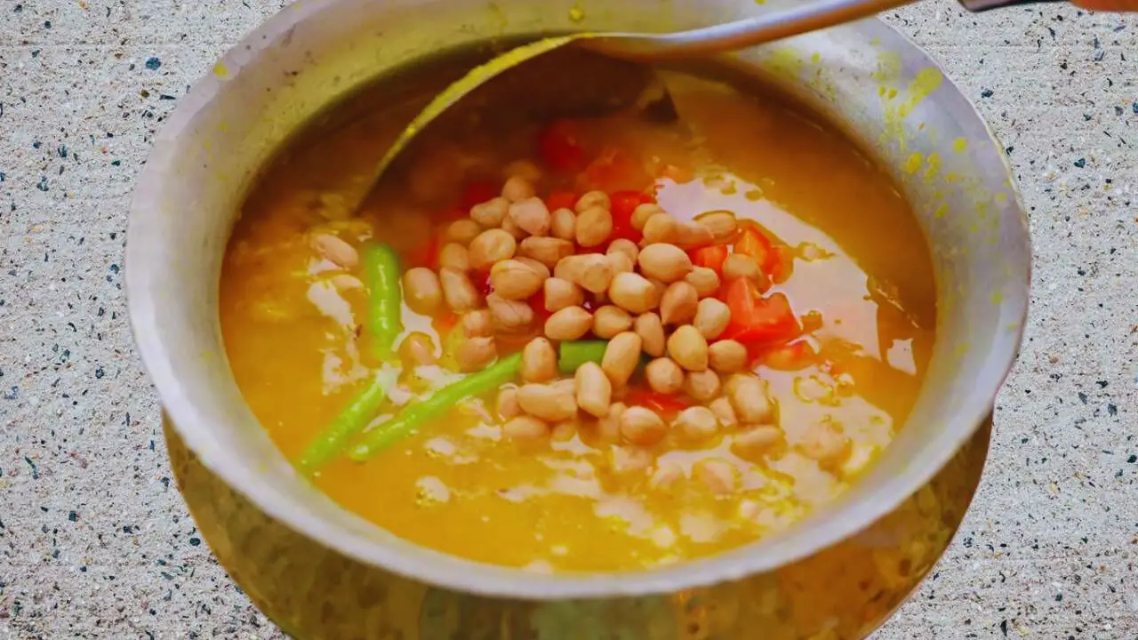 Adding tomatoes, chilies, and peanuts