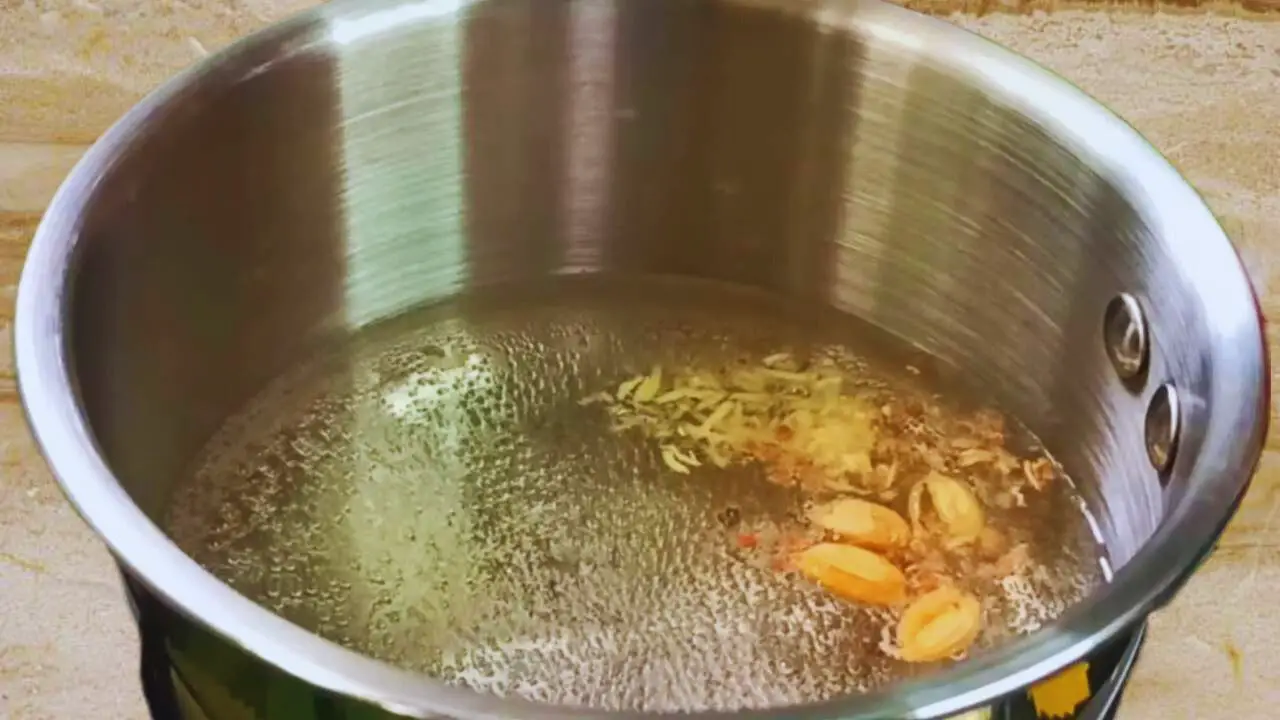 Boiling cardamom and ginger in water 