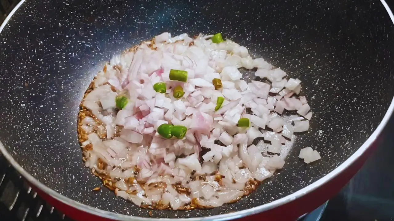 Poha recipe step 4 Frying onions and chilies