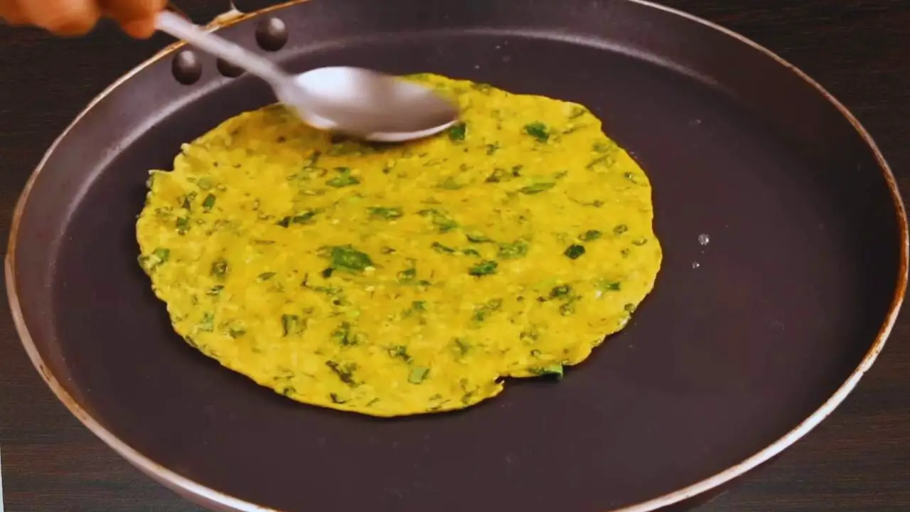 Greasing Methi Paratha with oil