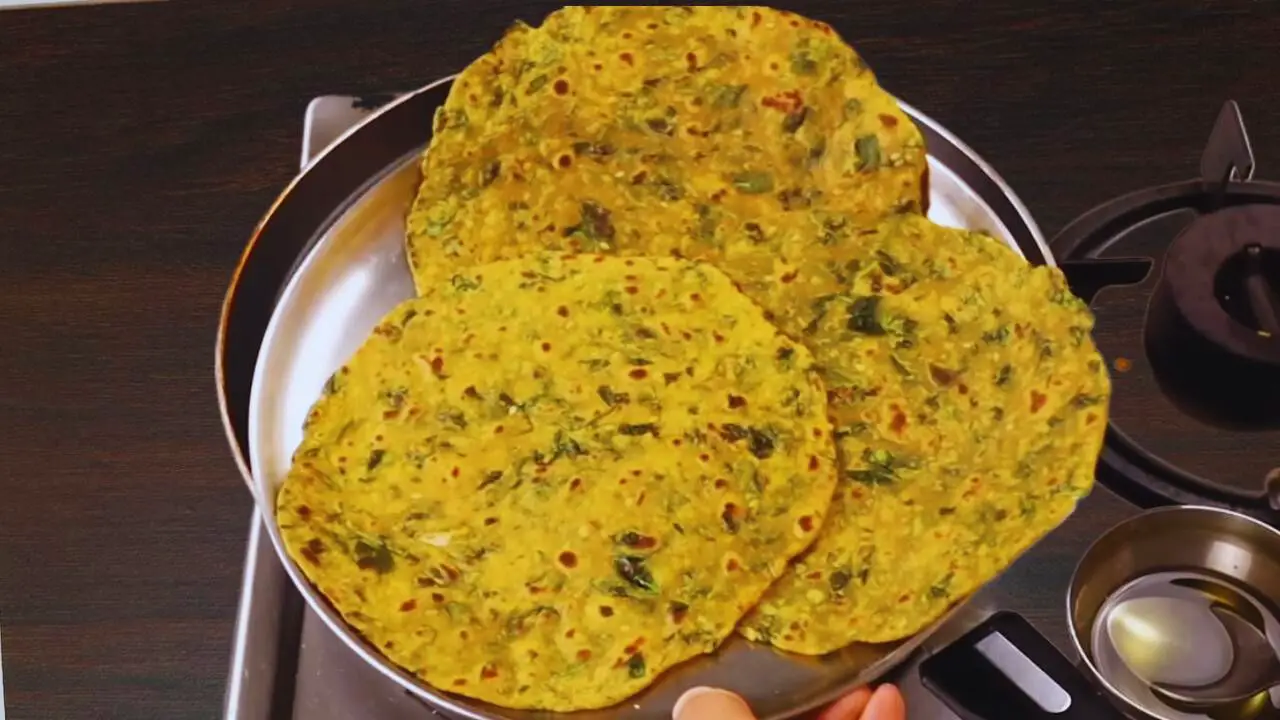 Keeping fried Methi Paratha on a plate 