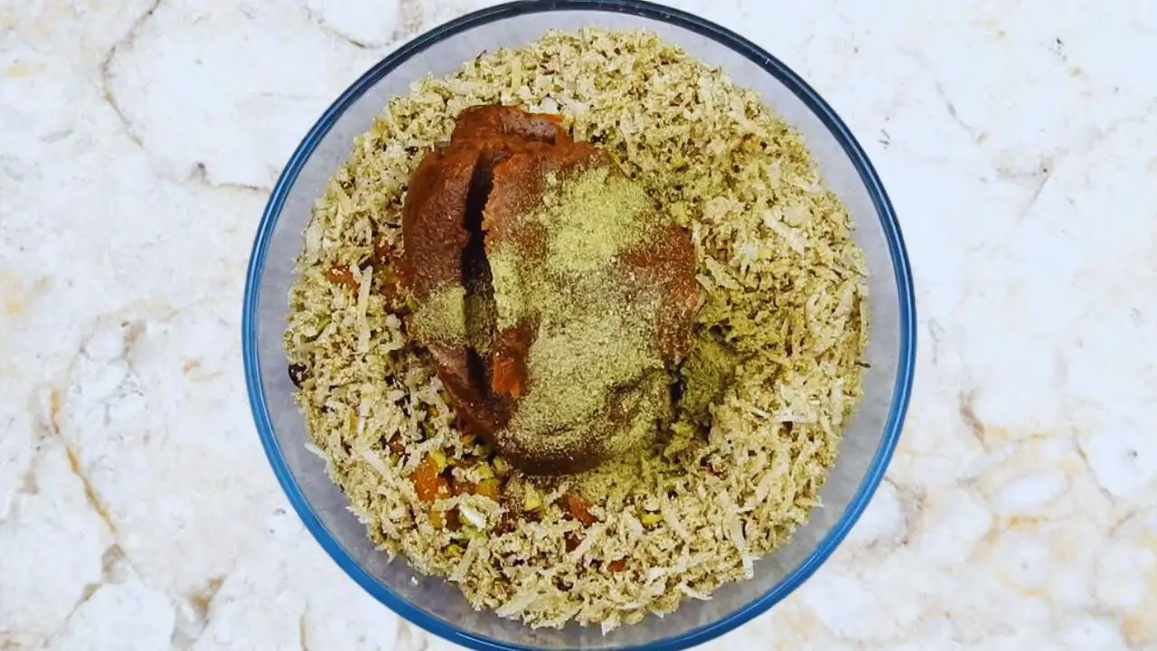 Dry fruit laddu recipe step 9 Adding cardamom powder