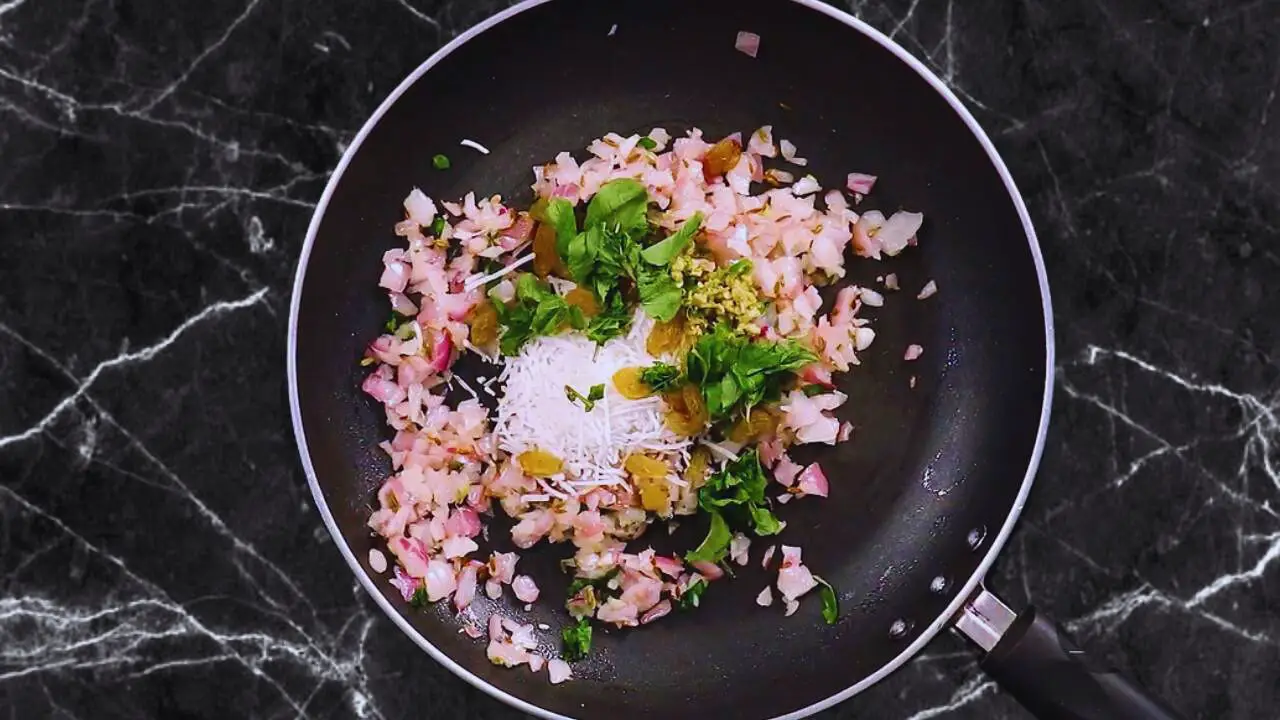 Chana dal samosa recipe step 4 Adding coconut, raisins and other ingredients