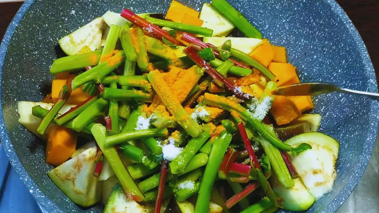 Adding pui shak stems, salt, and turmeric 