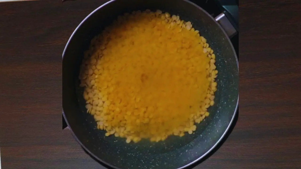 Adding salt and turmeric to boil dal