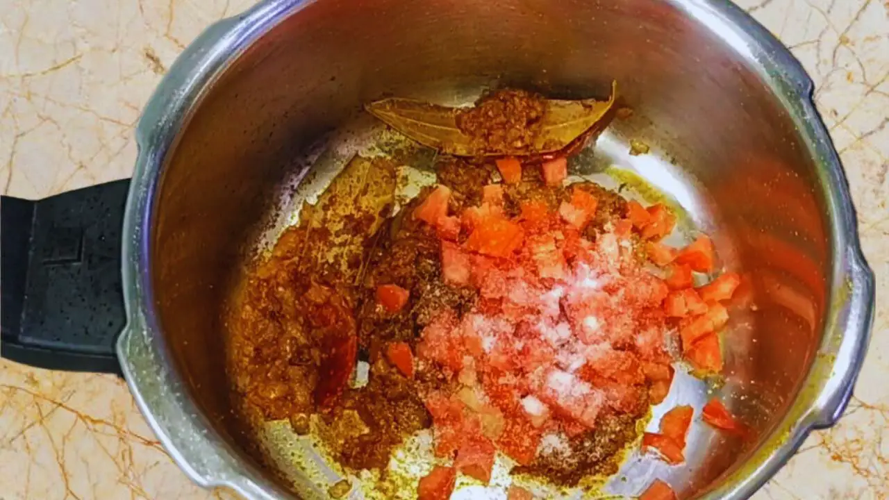 Chicken khichdi recipe step 8 Adding tomatoes and salt