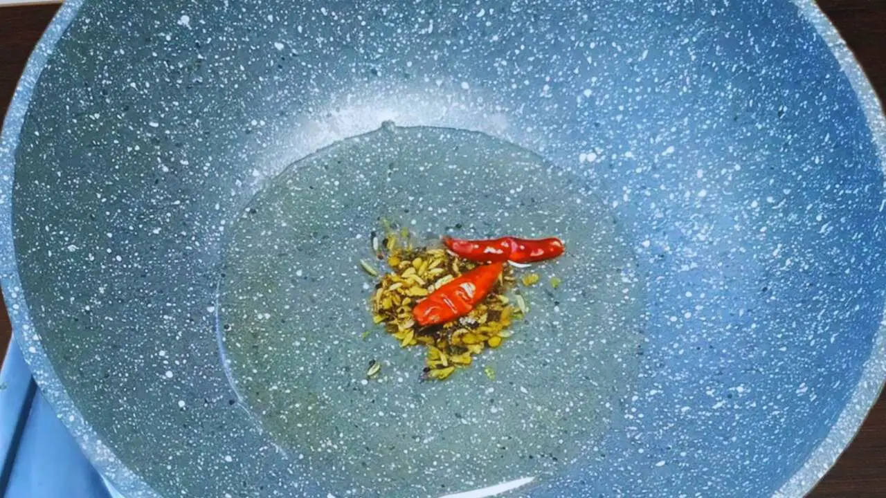 Frying red chilies and panch foron