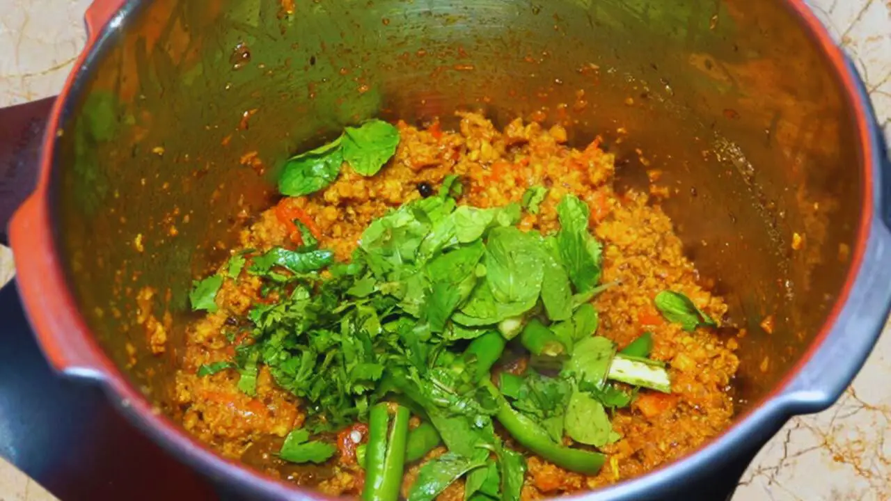 Adding coriander, pudina, and chilies 