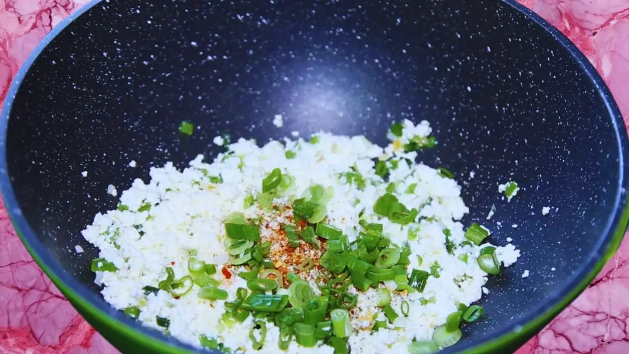 Adding spices and spring onion greens