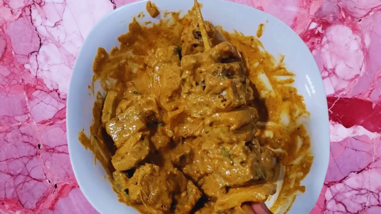 Putting marinated pieces into skewer