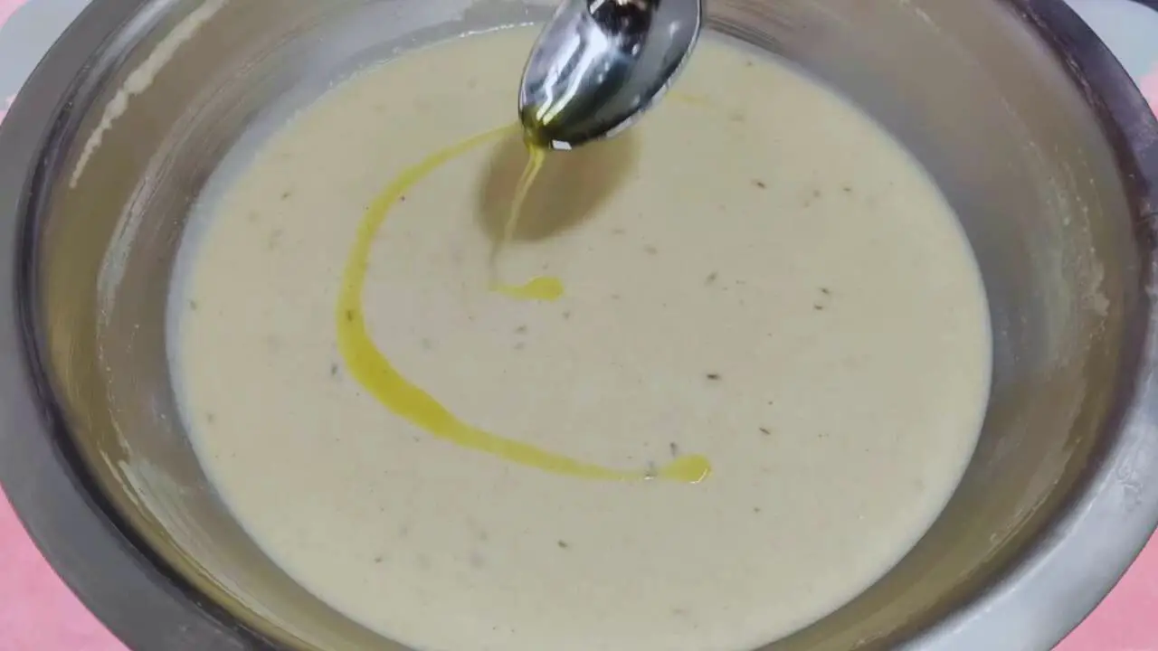 Malpua recipe step 7 Adding ghee to the batter