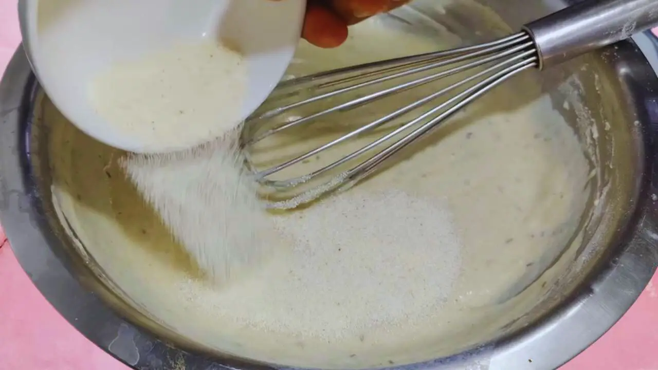 Malpua recipe step 4 Adding suji