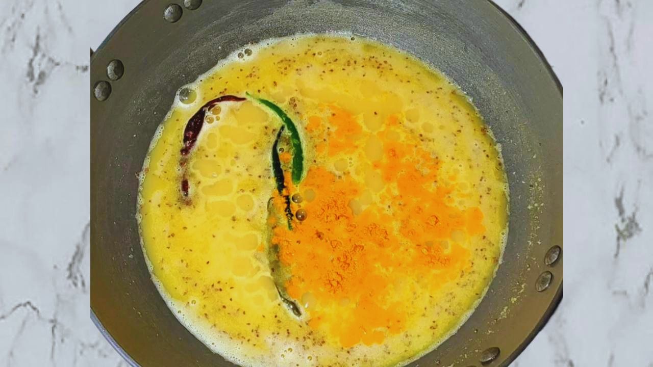 Adding chilies, turmeric, salt and sugar