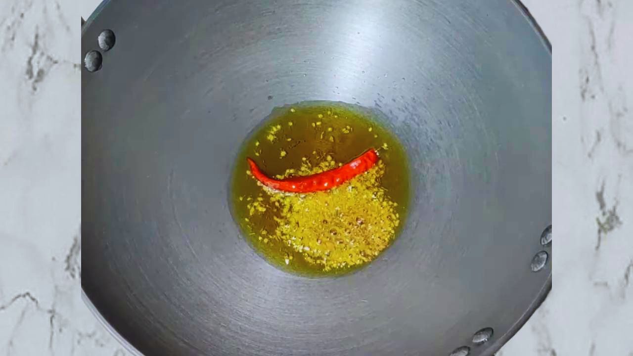 Frying radhuni and red chili