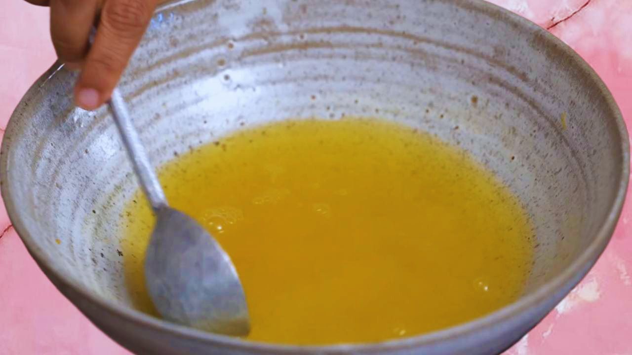 Mixing salt and turmeric in water 